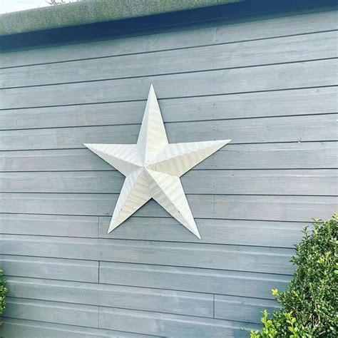 why do people put metal stars on their houses|big barn star.